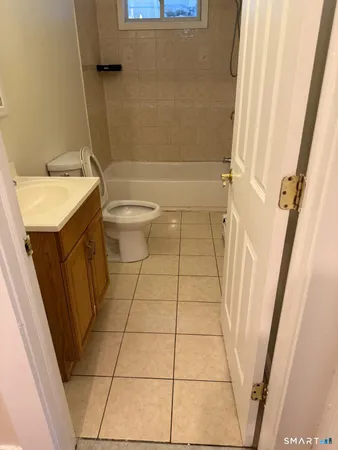 a bathroom with a sink a toilet and a shower
