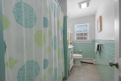 a bathroom with a toilet sink and shower