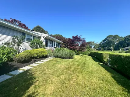 a front view of a house with a garden