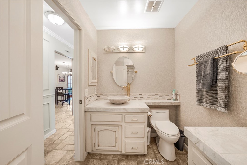 4648 Marlene Drive Santa Maria, CA 93455 - Photo 14 of 37 a bathroom with a granite countertop toilet sink and mirror