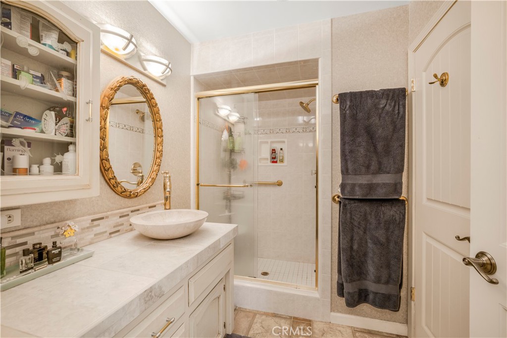 4648 Marlene Drive Santa Maria, CA 93455 - Photo 20 of 37 a bathroom with a granite countertop shower a sink and a mirror