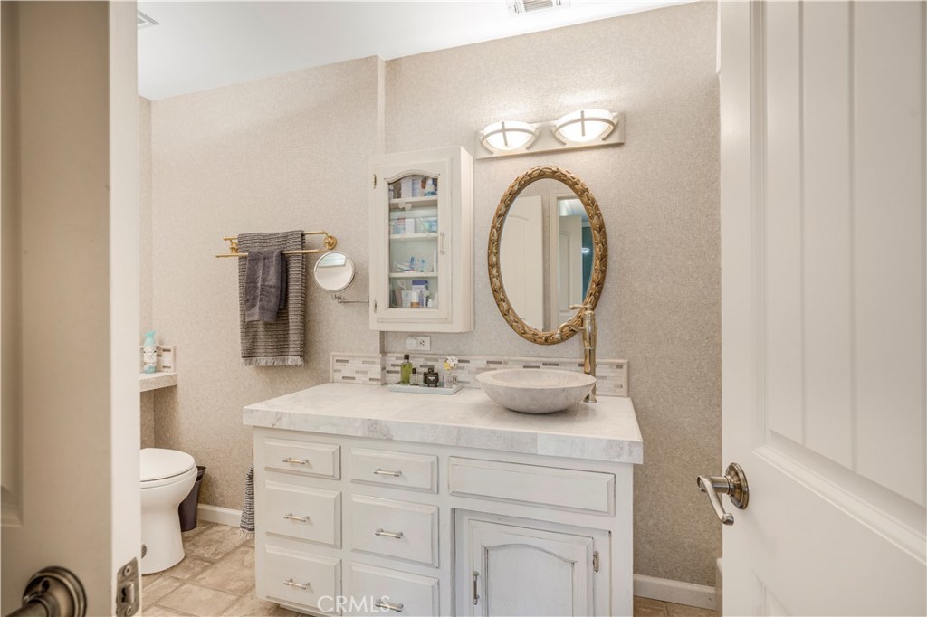 4648 Marlene Drive Santa Maria, CA 93455 - Photo 28 of 37 a bathroom with a toilet a sink and a mirror
