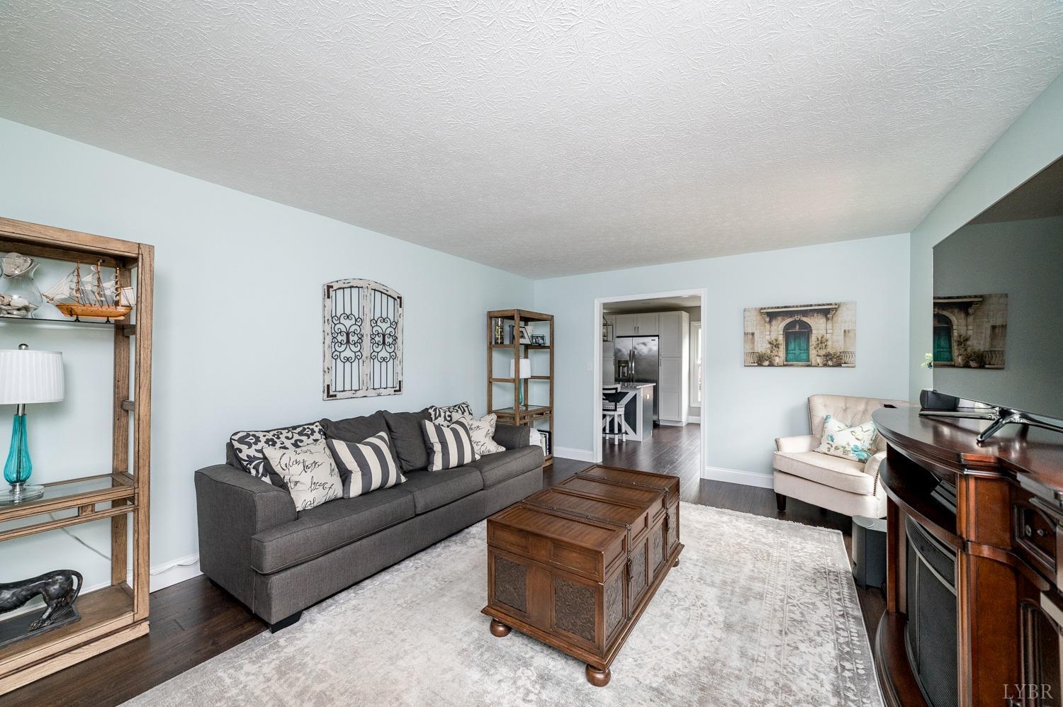5335 Perrowville Road Forest, VA 24551 - Photo 17 of 65 a living room with furniture flat screen tv and a couch