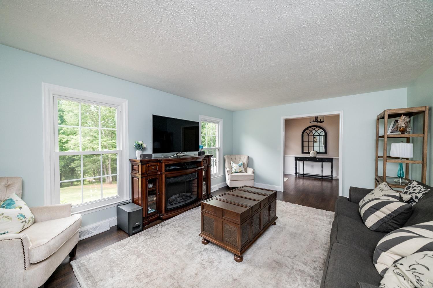 5335 Perrowville Road Forest, VA 24551 - Photo 18 of 65 a living room with furniture and a flat screen tv