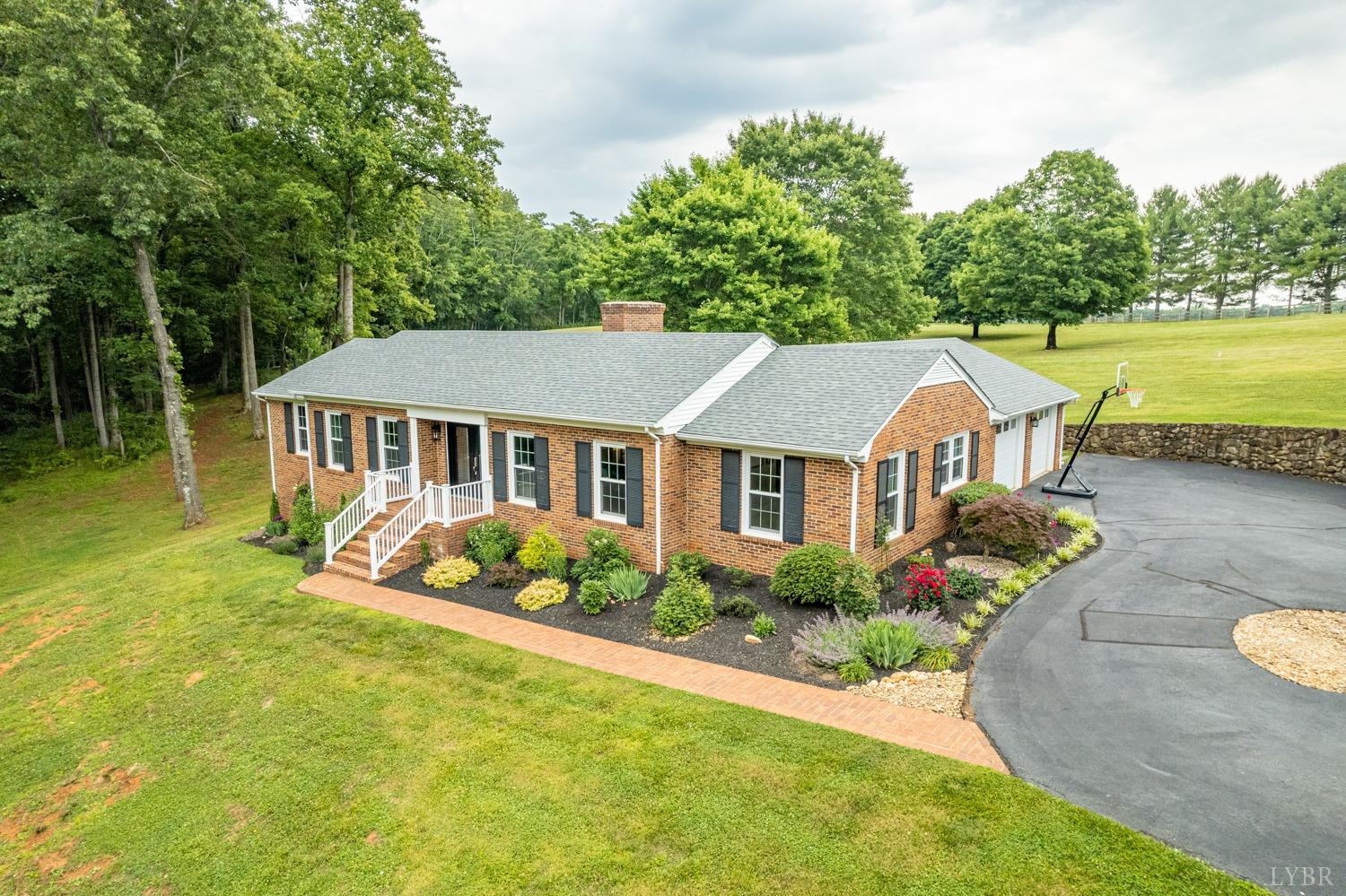 5335 Perrowville Road Forest, VA 24551 - Photo 2 of 65 a aerial view of a house with swimming pool next to a big yard