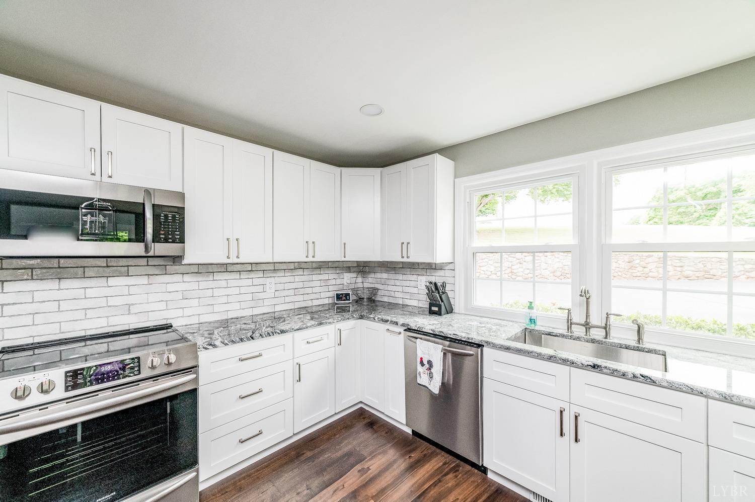 5335 Perrowville Road Forest, VA 24551 - Photo 27 of 65 a kitchen with a sink stove top oven and cabinets