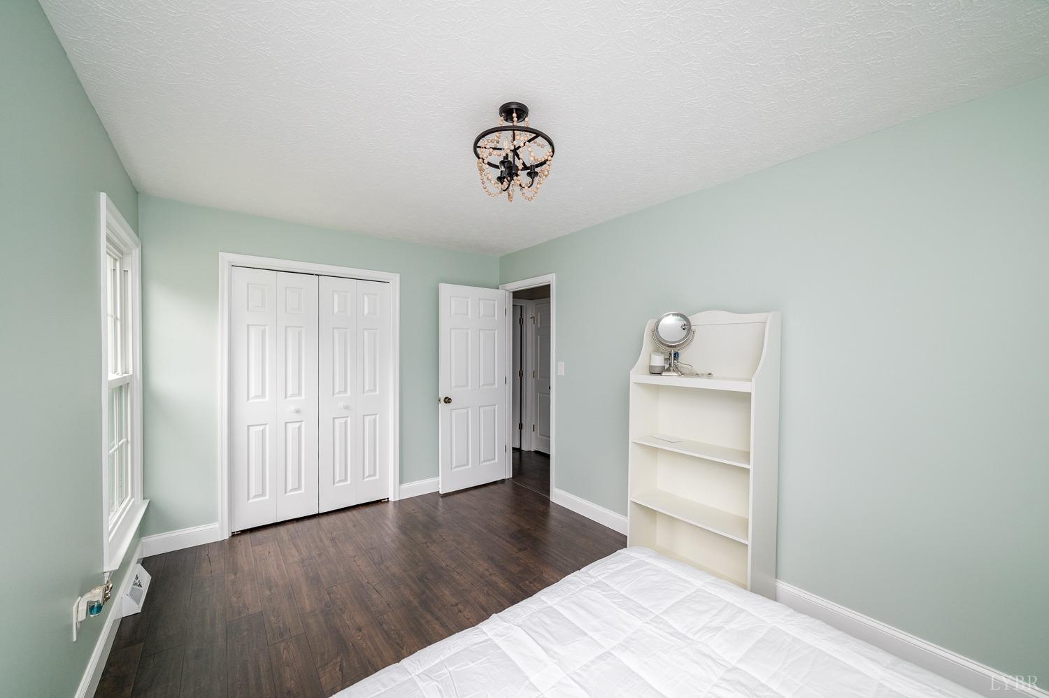 5335 Perrowville Road Forest, VA 24551 - Photo 51 of 65 a view of a hardwood floor and a ceiling fan in a room