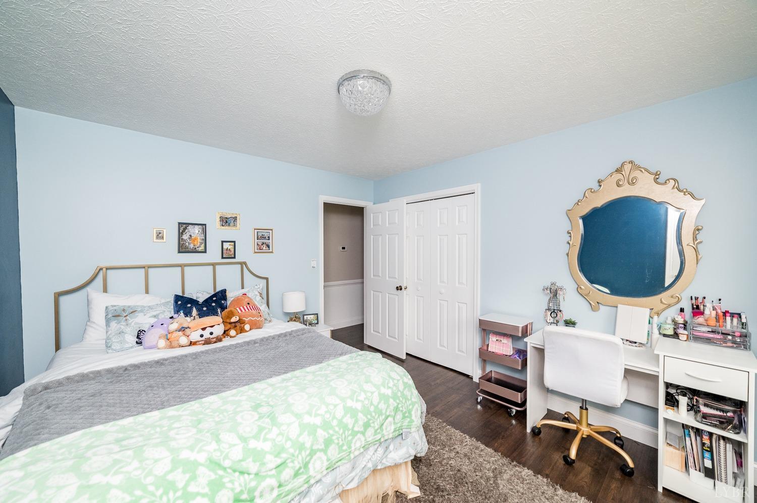 5335 Perrowville Road Forest, VA 24551 - Photo 54 of 65 a bedroom with a bed and a chandelier