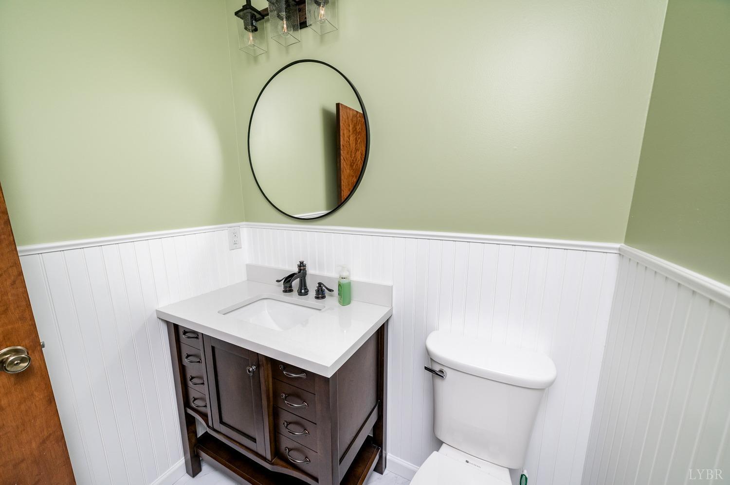 5335 Perrowville Road Forest, VA 24551 - Photo 56 of 65 a bathroom with a sink a toilet and a mirror
