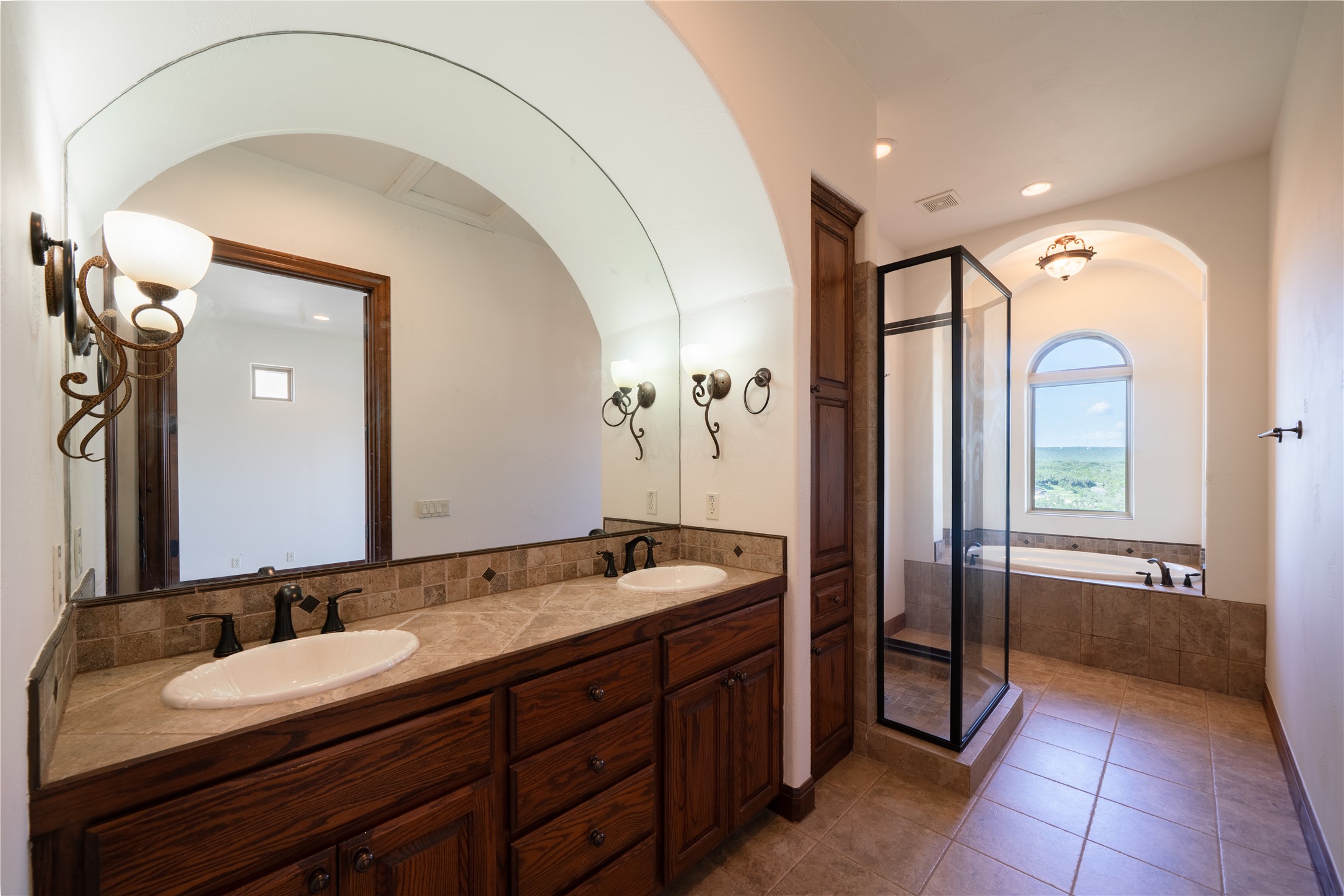 17545 West Reed Park Road, Unit 2 Jonestown, TX 78645 - Photo 20 of 39 a spacious bathroom with a granite countertop sink mirror and bathtub