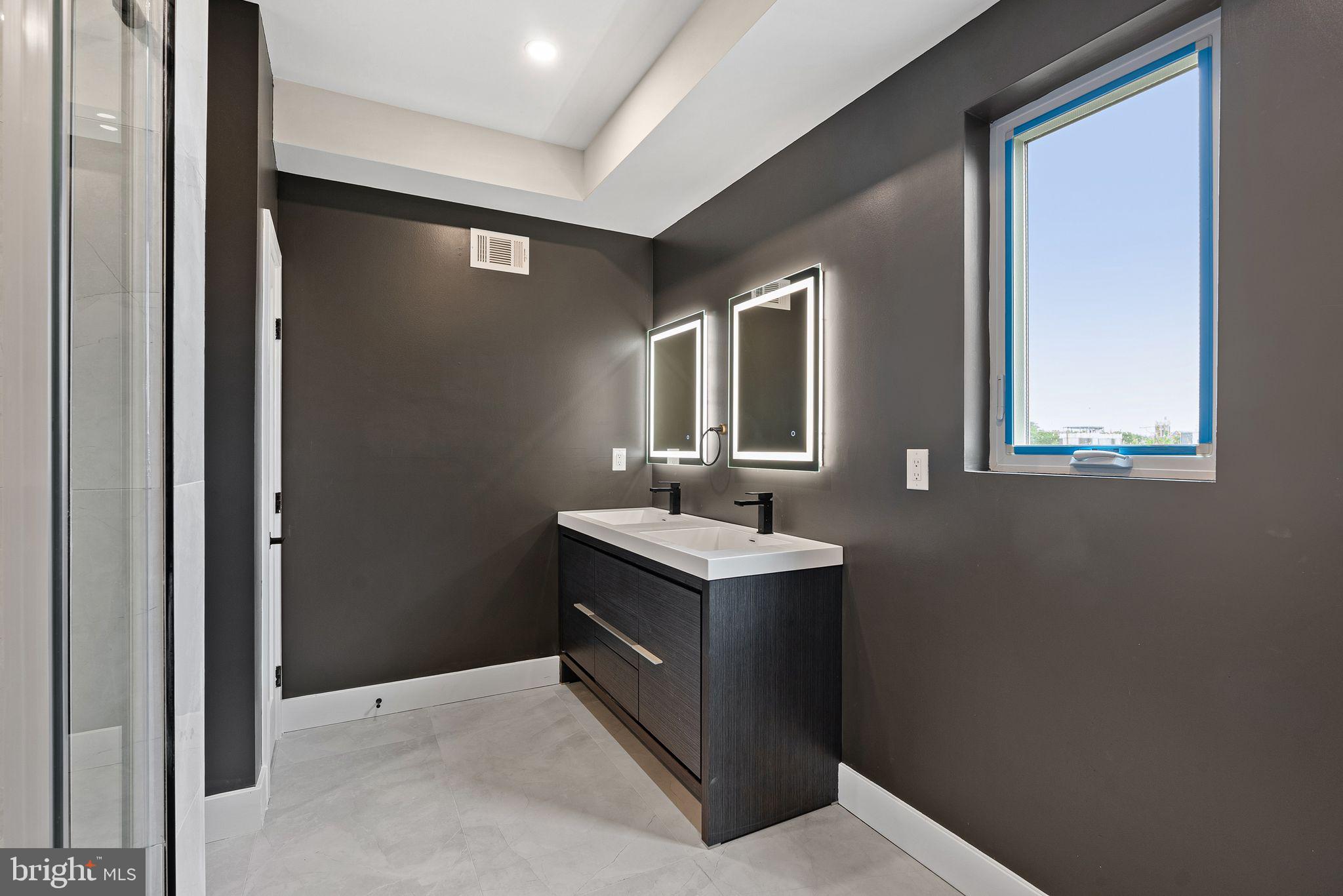 2722 Wharton Street Philadelphia, PA 19146 - Photo 19 of 46 a bathroom with a toilet sink vanity and mirror