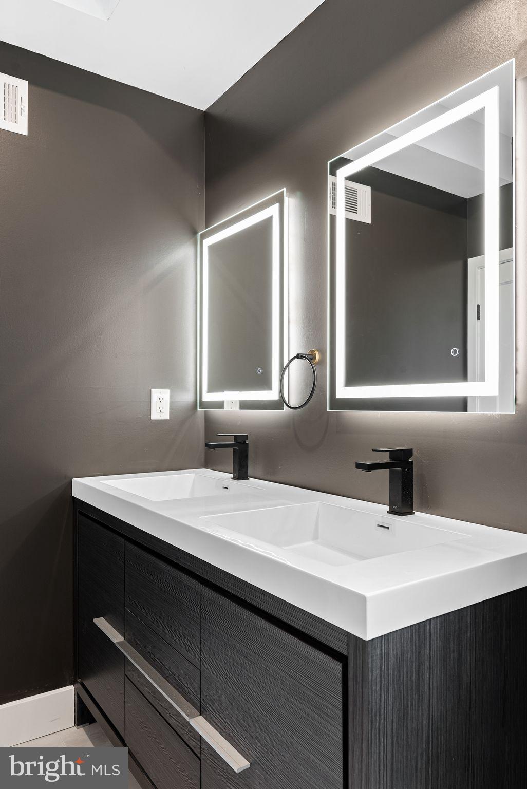 2722 Wharton Street Philadelphia, PA 19146 - Photo 20 of 46 a bathroom with a sink and a mirror