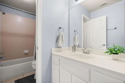 a bathroom with a double vanity sink and a bathtub