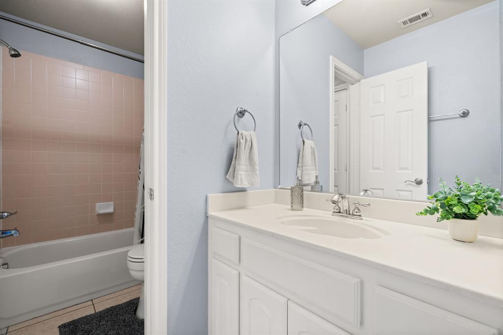 2703 Pottery Trail Corinth, TX 76210 - Photo 26 of 40 a bathroom with a double vanity sink and a bathtub