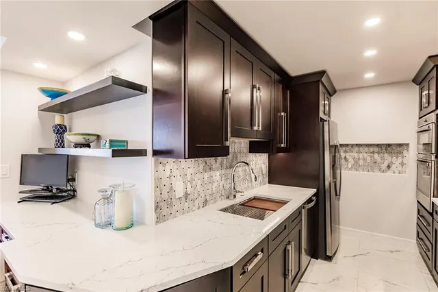 a kitchen with a sink a refrigerator and cabinets
