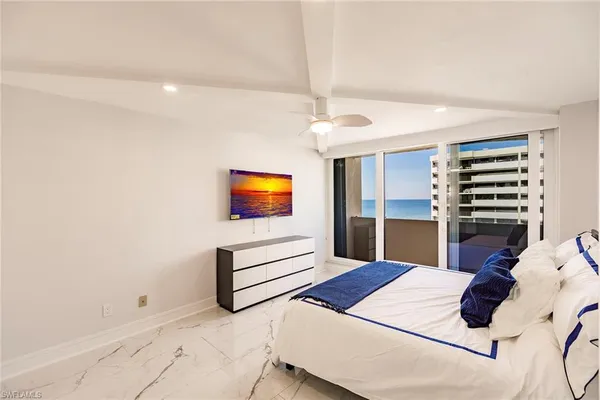 a bed room with a bed and a television
