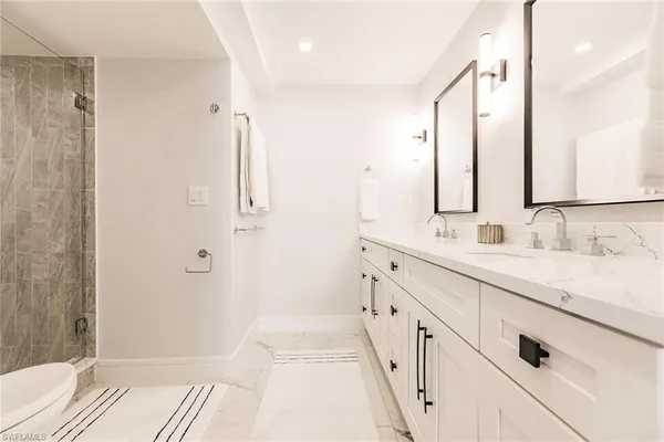 a bathroom with double sink and a mirror