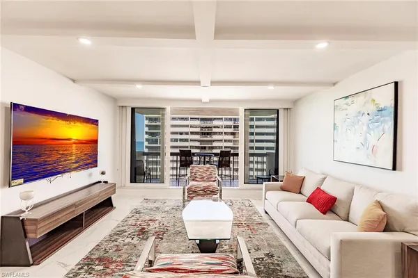 a living room with furniture and a flat screen tv