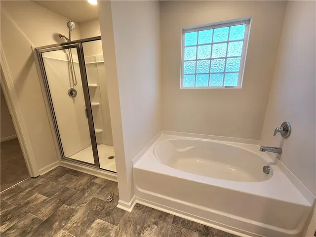 a bathroom with a bathtub and a shower