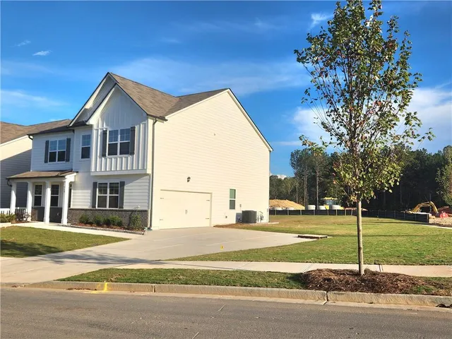 a view of a house next to a yard