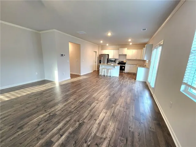 a living room with furniture and kitchen view
