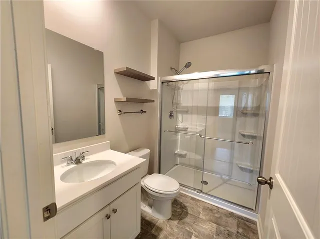 a bathroom with a sink toilet and shower