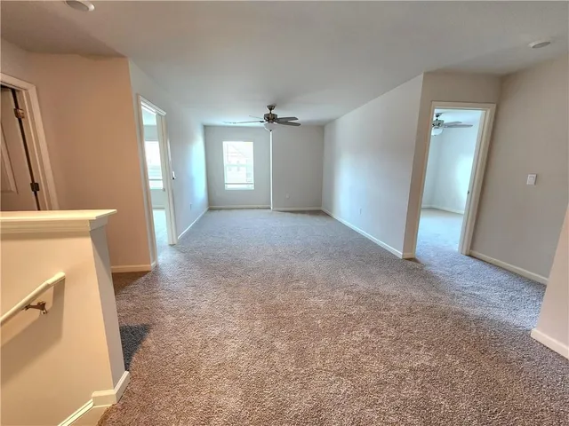 an empty room with windows and cabinet