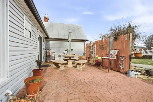 a view of a terrace with chairs and couches in the patio