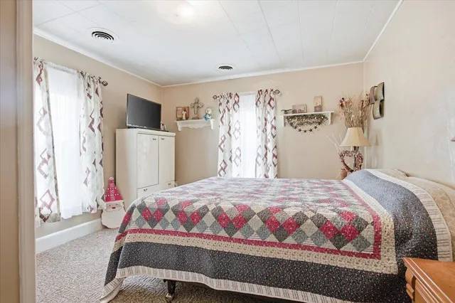 a bedroom with a bed and a window