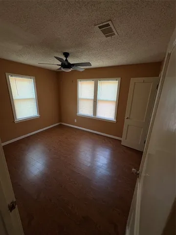 a view of empty room with a fireplace