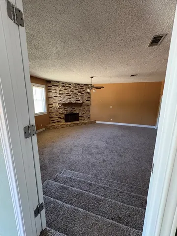 an empty room with windows and entrance