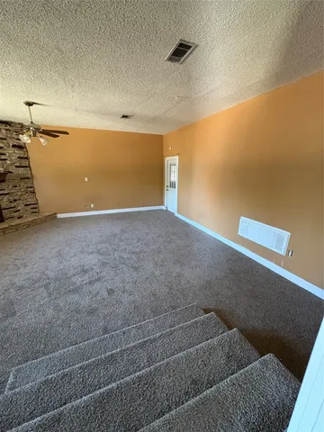 a kitchen with refrigerator and cabinets