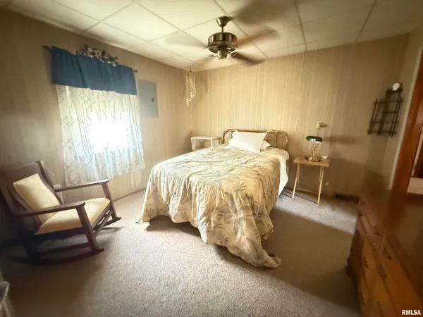 a bed room with a bed and a chair