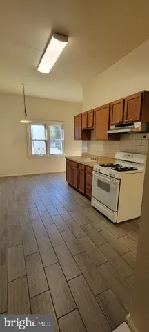 a kitchen with stainless steel appliances a stove a sink and a refrigerator