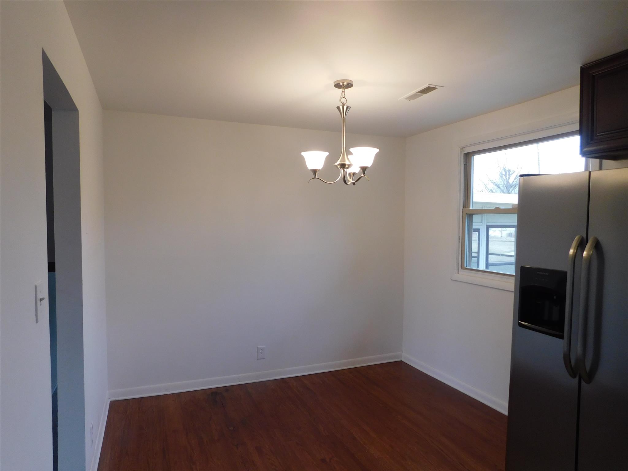 405 Burch Road Clarksville, TN 37042 - Photo 11 of 30 wooden floor in an empty room with a mirror