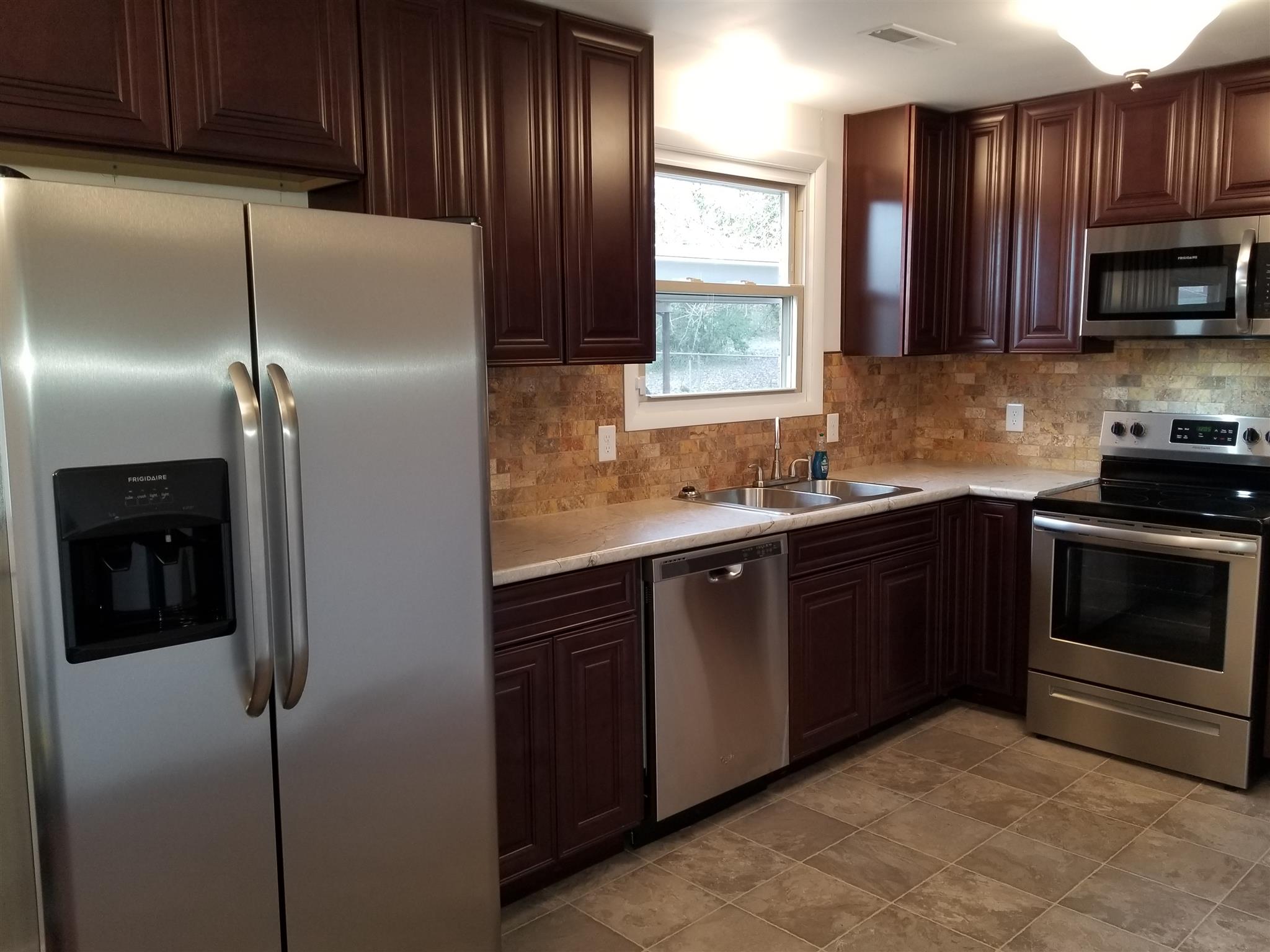 405 Burch Road Clarksville, TN 37042 - Photo 13 of 30 a kitchen with stainless steel appliances granite countertop a refrigerator a sink a stove and cabinets