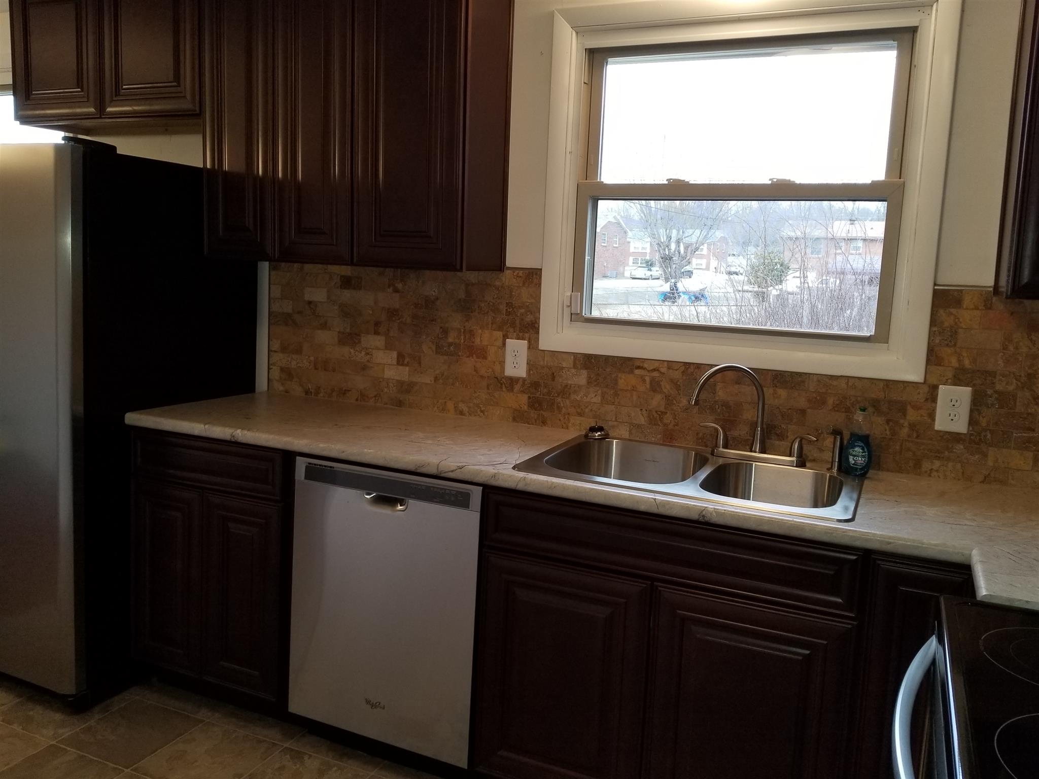 405 Burch Road Clarksville, TN 37042 - Photo 14 of 30 a kitchen with a sink a window and cabinets