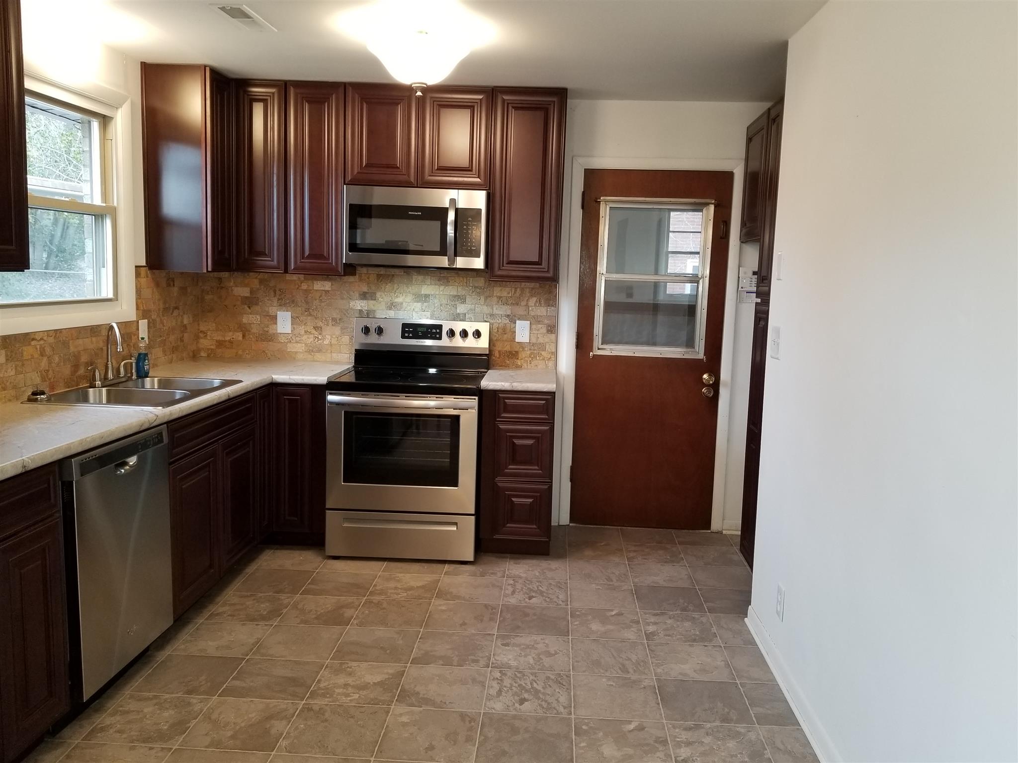 405 Burch Road Clarksville, TN 37042 - Photo 15 of 30 a kitchen with stainless steel appliances granite countertop a refrigerator and a stove top oven