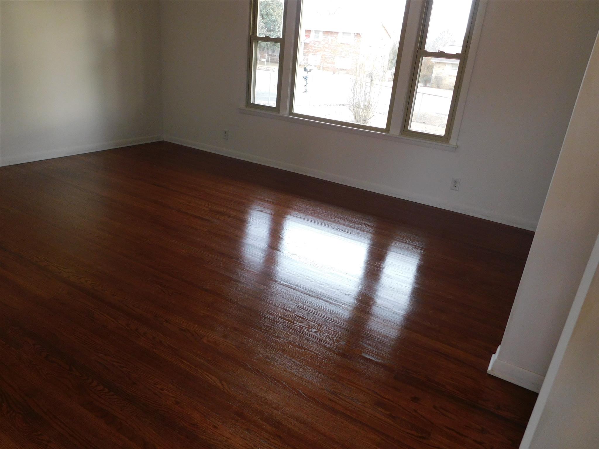 405 Burch Road Clarksville, TN 37042 - Photo 4 of 30 an empty room with wooden floor and windows