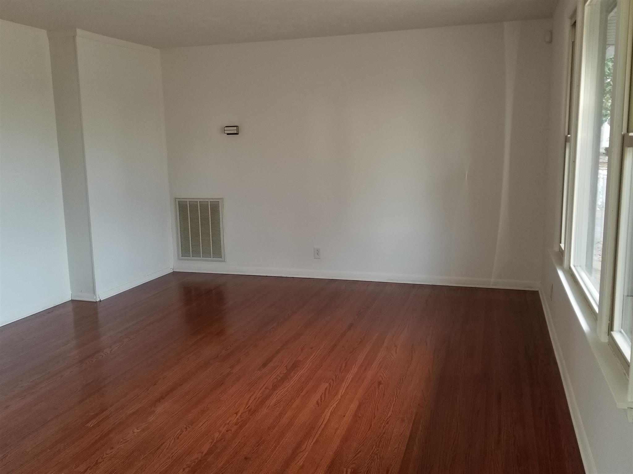 405 Burch Road Clarksville, TN 37042 - Photo 5 of 30 a view of an empty room with wooden floor and a window