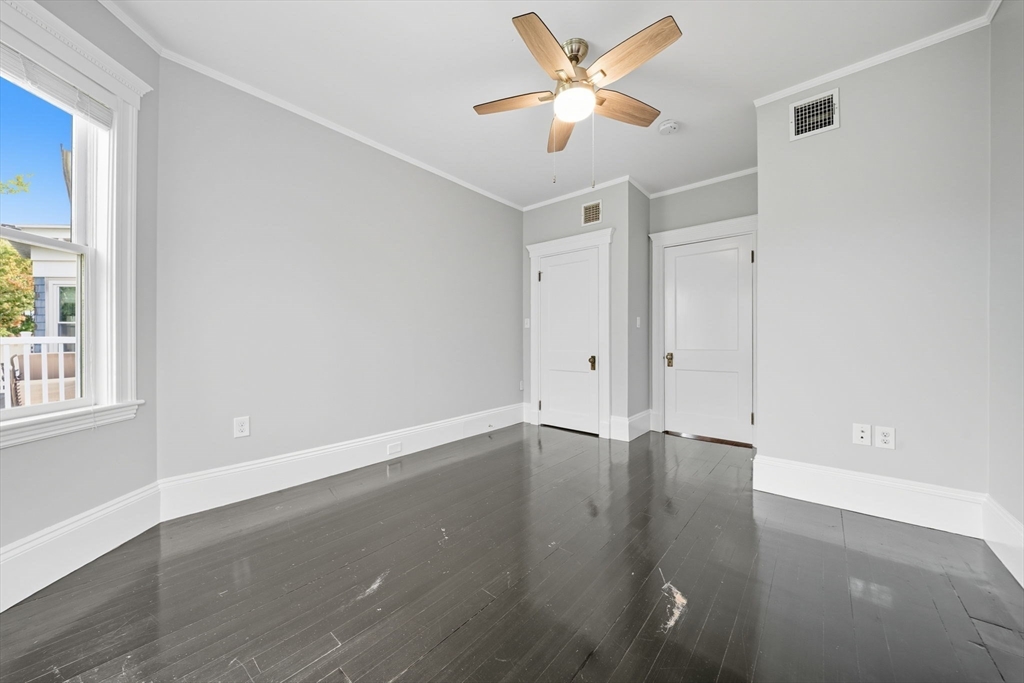 22 Trescott Street, Unit 3 Boston, MA 02125 - Photo 14 of 22 an empty room with wooden floor fan and windows