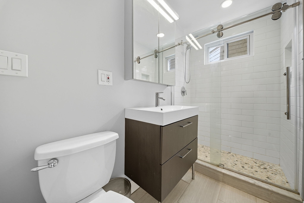 22 Trescott Street, Unit 3 Boston, MA 02125 - Photo 16 of 22 a bathroom with a sink toilet and shower