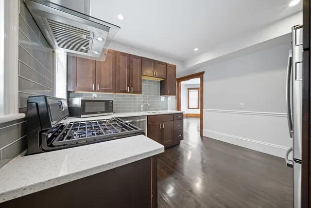 a kitchen with kitchen island a counter top space a sink and appliances
