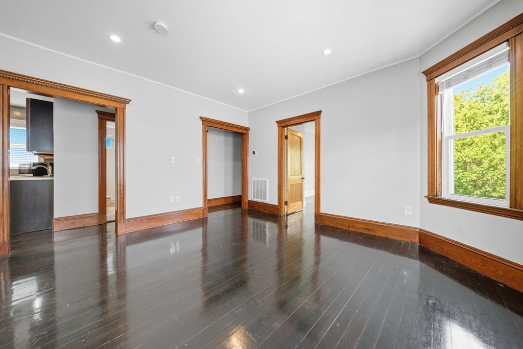 22 Trescott Street, Unit 3 Boston, MA 02125 - Photo 9 of 22 a view of an empty room with wooden floor and a window