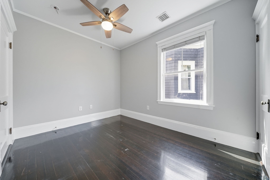 22 Trescott Street, Unit 3 Boston, MA 02125 - Photo 10 of 22 a view of an empty room with wooden floor and a window
