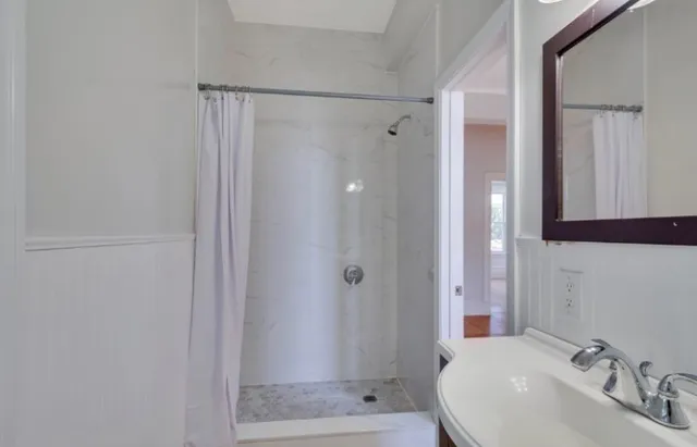a bathroom with a shower and a sink