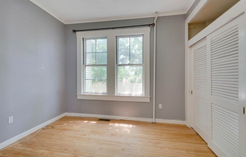 12 Fiske Street, Unit 1 Waltham, MA 02451 - Photo 16 of 18 a view of an empty room with wooden floor and a window