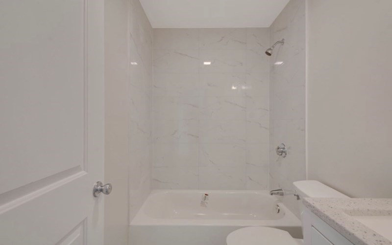 12 Fiske Street, Unit 1 Waltham, MA 02451 - Photo 8 of 18 a bathroom with a bathtub and toilet
