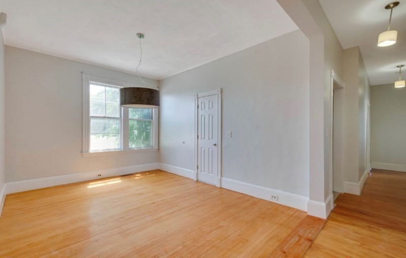 12 Fiske Street, Unit 1 Waltham, MA 02451 - Photo 9 of 18 a view of empty room with wooden floor and fan