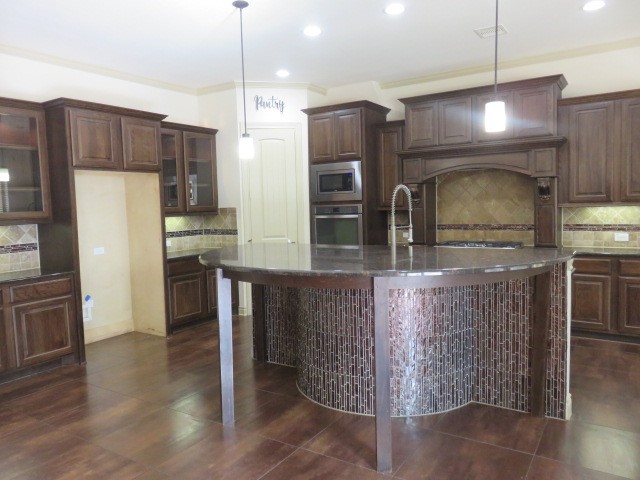 2607 Alan Lake Lane Spring, TX 77388 - Photo 6 of 42 a kitchen with stainless steel appliances wooden cabinets a refrigerator and a stove